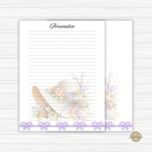 May include: White lined stationery with a watercolor illustration of a sun hat adorned with flowers and ribbons. The word "Personalize" is written at the top. A row of purple bows decorates the bottom.
