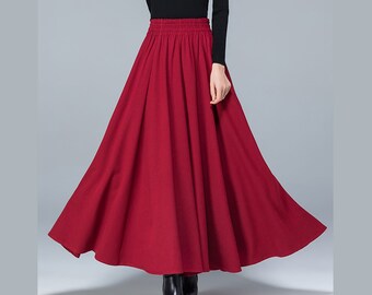 May include: A long, red, flowing skirt with an elastic waistband. The skirt is made of a soft, comfortable fabric and has a simple, elegant design.