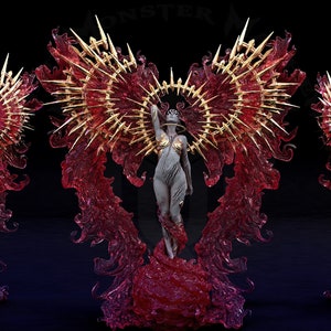 May include: A figurine of a woman with wings made of red and gold flames. The woman is standing on a red base and has a crown of gold thorns.