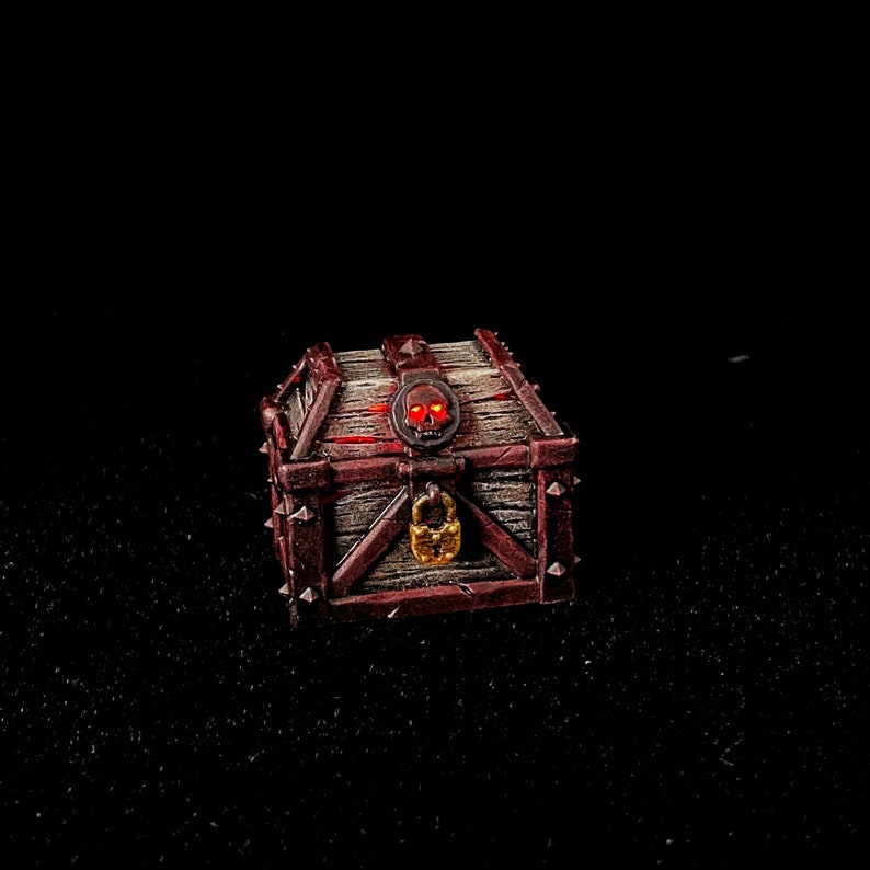 May include: A wooden treasure chest with a skull and crossbones design and a padlock. The chest is painted brown and red with metal accents.