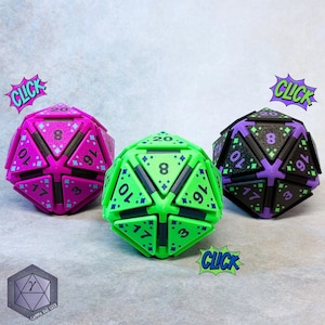 May include: Three twenty-sided dice featuring a geometric, multi-part construction with black structural accents. One die is magenta, one is bright green, and one is black with purple accents. Each face displays numbers and small diamond patterns.