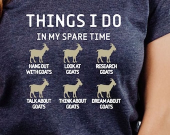 May include: A navy blue t-shirt with the text "THINGS I DO IN MY SPARE TIME" and a series of illustrations of goats with text describing activities related to goats, such as "hangout with goats", "look at goats", "research goats", "talk about goats", "think about goats", and "dream about goats".