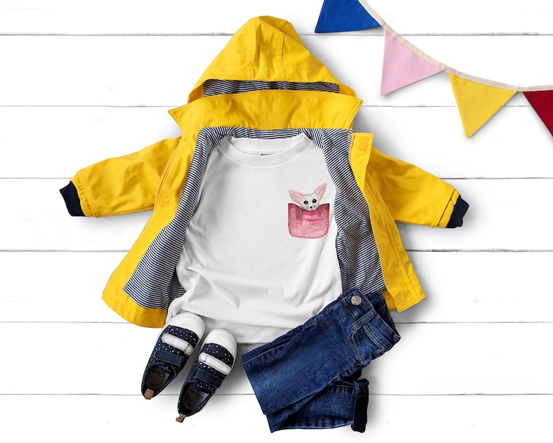 May include: A yellow hooded raincoat with navy trim, a white t-shirt with a pocket design featuring a fox, blue jeans, and navy shoes with white spots. A colourful banner is in the background.