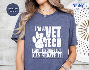 May include: A heather navy blue t-shirt with a white paw print and the text "I'm a Vet Tech I can't fix crazy but I can sedate it."
