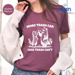 a woman wearing a t - shirt that says more trash can less trash can '