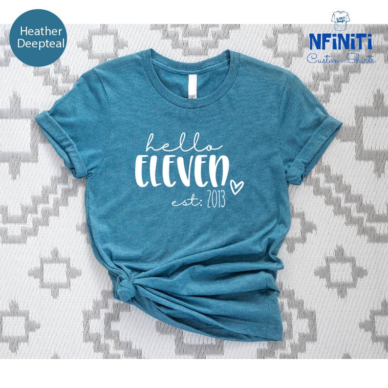 a blue t - shirt with the words hell eleven printed on it