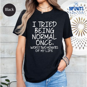 a woman wearing a black t - shirt that says i tried being normal once
