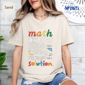 a woman wearing a t - shirt that says math gives us hope that every problem