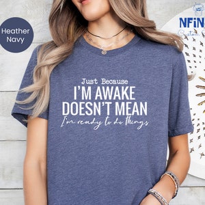 a woman wearing a t - shirt that says i'm awake doesn't
