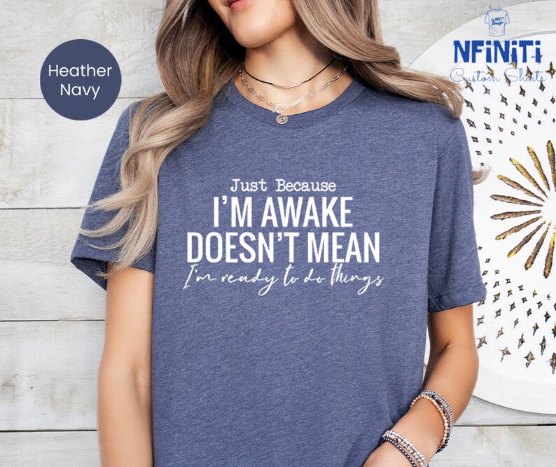 a woman wearing a t - shirt that says i'm awake doesn't