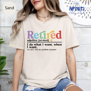a woman wearing a t - shirt that says retired