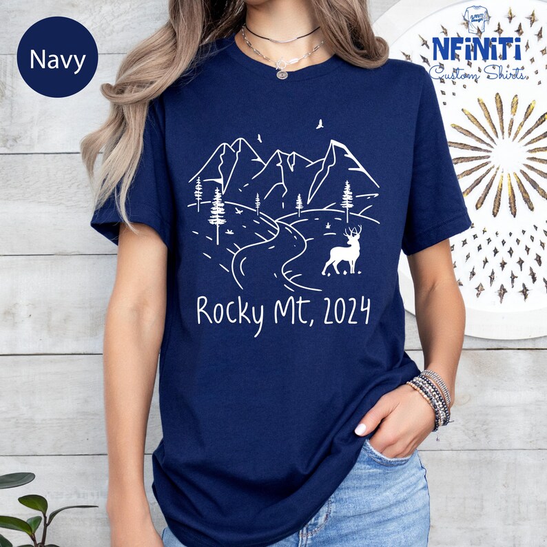 a woman wearing a t - shirt that says rocky mtt