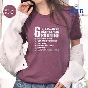 a woman in a maroon shirt is talking on a cell phone