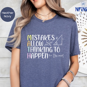 May include: A heather navy blue t-shirt with the text "Mistakes Allow Thinking To Happen" in colorful letters. The text is accompanied by a geometric shape and a mathematical formula.