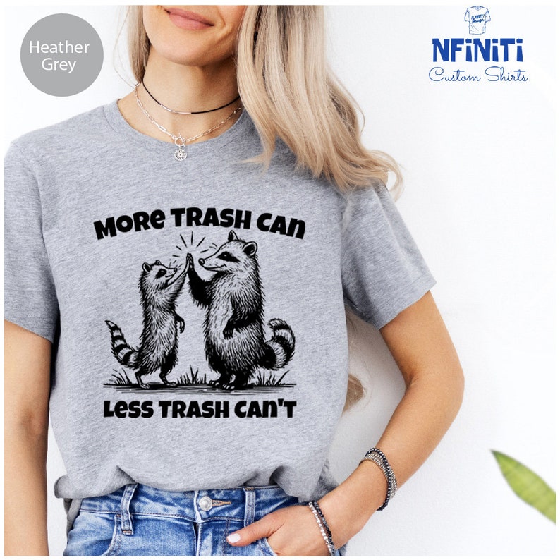 a woman wearing a t - shirt that says more trash can less trash can '