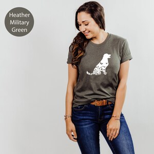 May include: A heather military green t-shirt with a white silhouette of a dog made up of butterflies.
