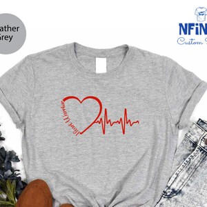 a t - shirt with a heart and heartbeat on it