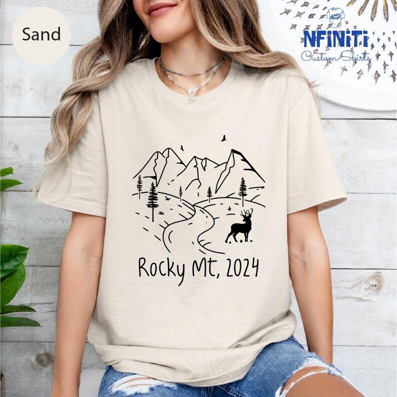 a woman wearing a t - shirt that says rocky mtn