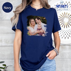a woman wearing a navy t - shirt with a picture of a man and a