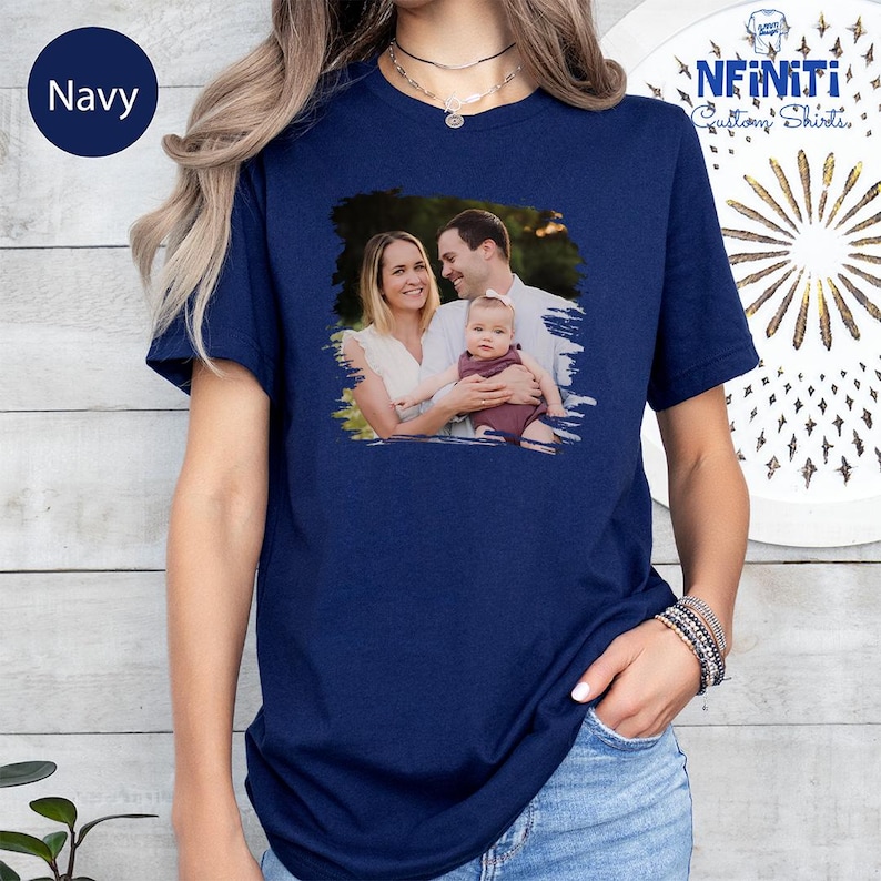 a woman wearing a navy t - shirt with a picture of a man and a