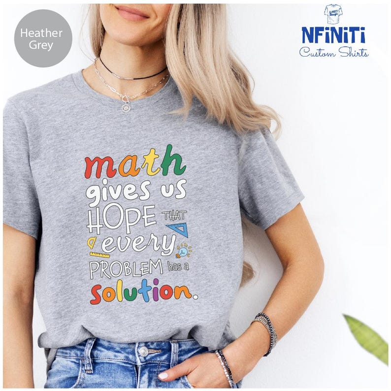 a woman wearing a t - shirt that says math gives us hope every problem solution