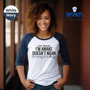 a woman wearing a t - shirt that says i'm awake doesn't