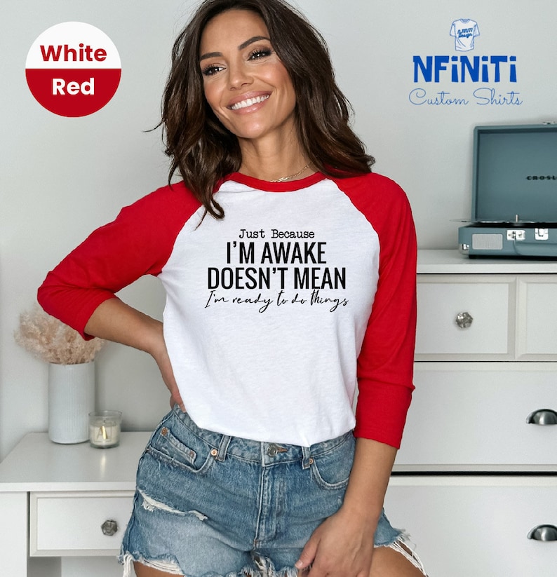 a woman wearing a red and white shirt with the words i'm awake doesn