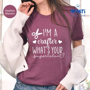 a woman wearing a t - shirt that says i'm a crater what '