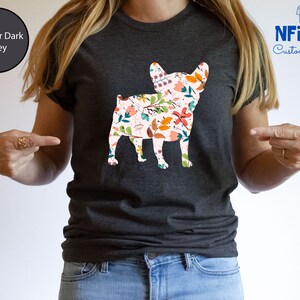 Peut inclure: Un t-shirt gris fonc&eacute; chin&eacute; avec un imprim&eacute; floral d'un bouledogue fran&ccedil;ais. Le texte "NFINITI Custom Shirts" est dans le coin sup&eacute;rieur droit de l'image.