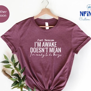 a t - shirt with the words i'm awake doesn't mean i