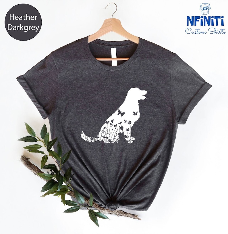 May include: Heather dark grey t-shirt with a white silhouette of a dog made up of flowers and butterflies. The text "NFINITI Custom Shirts" is in the top right corner of the image.