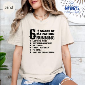 a woman wearing a t - shirt that says stages of marathon running