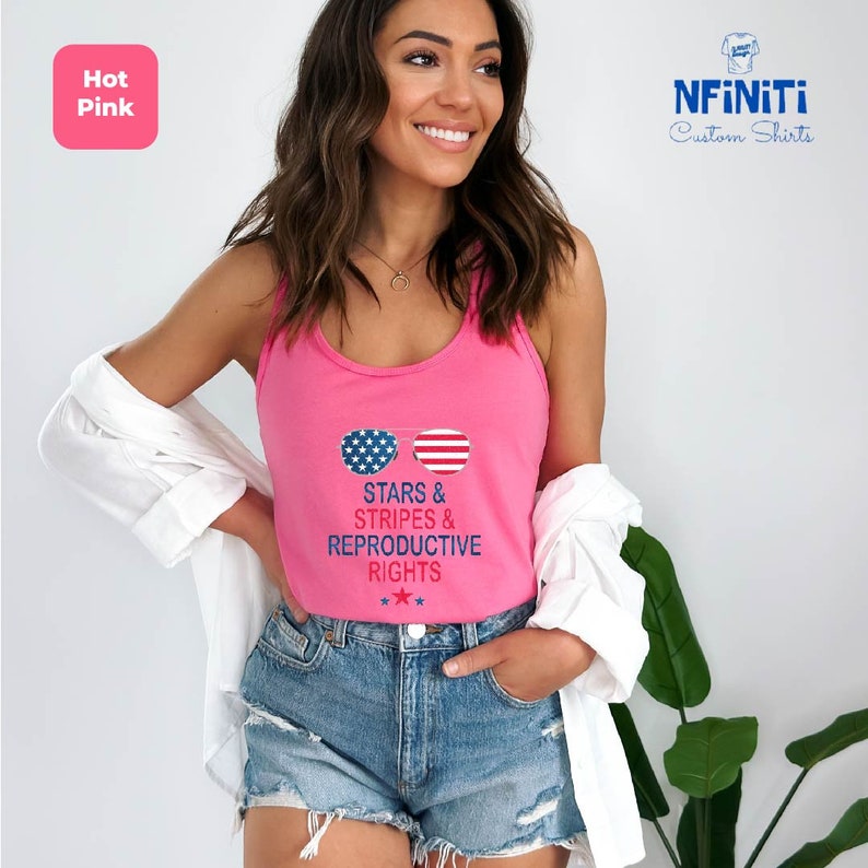a woman wearing a pink tank top with stars and stripes on it