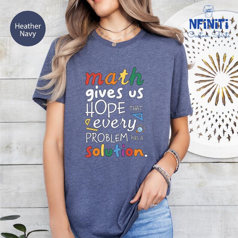 a woman wearing a t - shirt that says math gives us hope that every problem