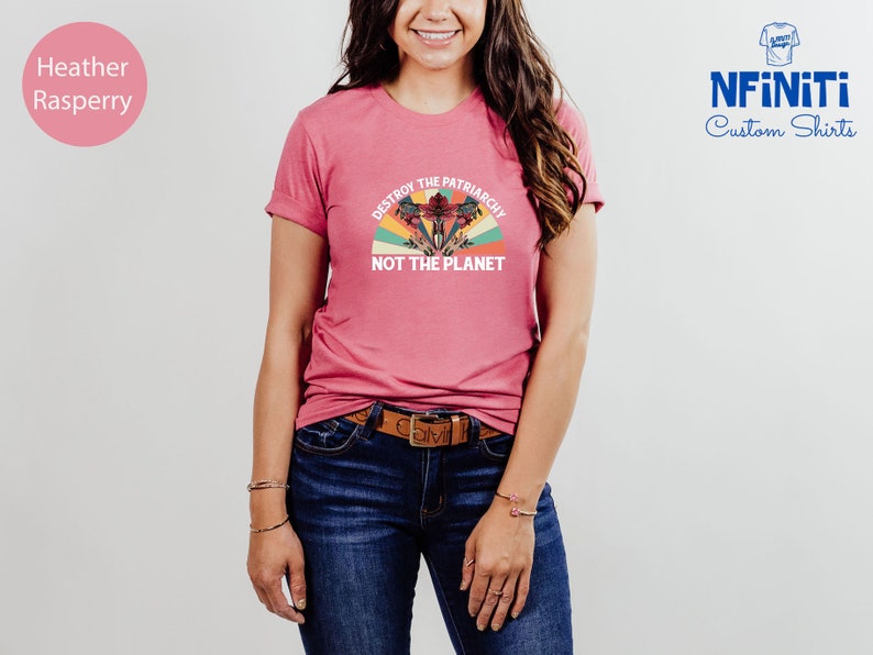 May include: A heather raspberry t-shirt with a vintage-style graphic that says "Destroy the Patriarchy, Not the Planet".