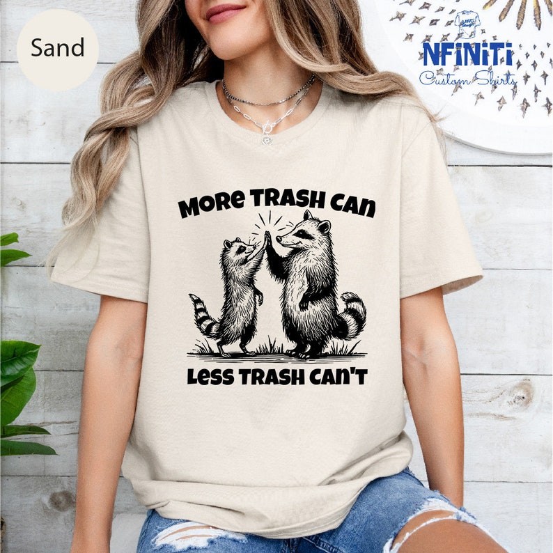 a woman wearing a t - shirt that says more trash can less trash can '