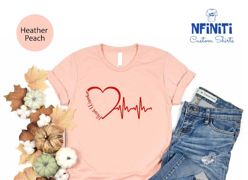 a pink shirt with a heart and heartbeat on it