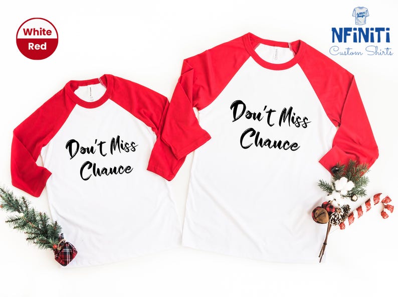 May include: Two white and red baseball shirts with the text "Don't Miss Chance" in black. The shirts are laid out on a white surface with a sprig of greenery and a red and white candy cane.