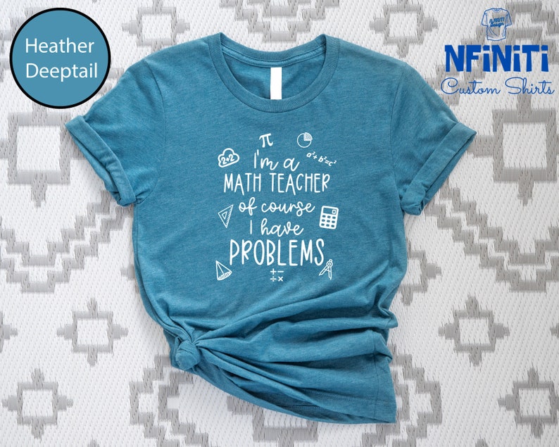 May include: A teal blue t-shirt with white text that reads "&pi; I'm a MATH TEACHER of course I have PROBLEMS". The text is surrounded by math symbols like a calculator, a compass, and a triangle.