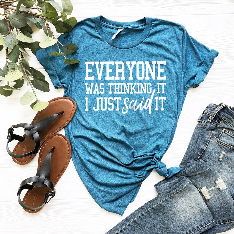 Pode incluir: Uma camiseta azul turquesa com o texto "Everyone was thinking it, I just said it" em branco.