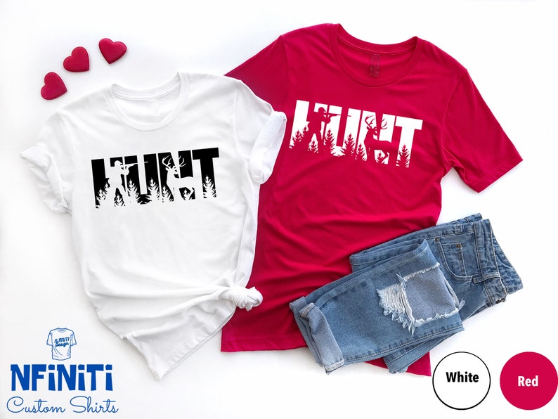 May include: Two t-shirts with the word "HUNT" in black and white, with a silhouette of a hunter and deer inside the letters. The shirts are on a white background with blue jeans and red hearts.