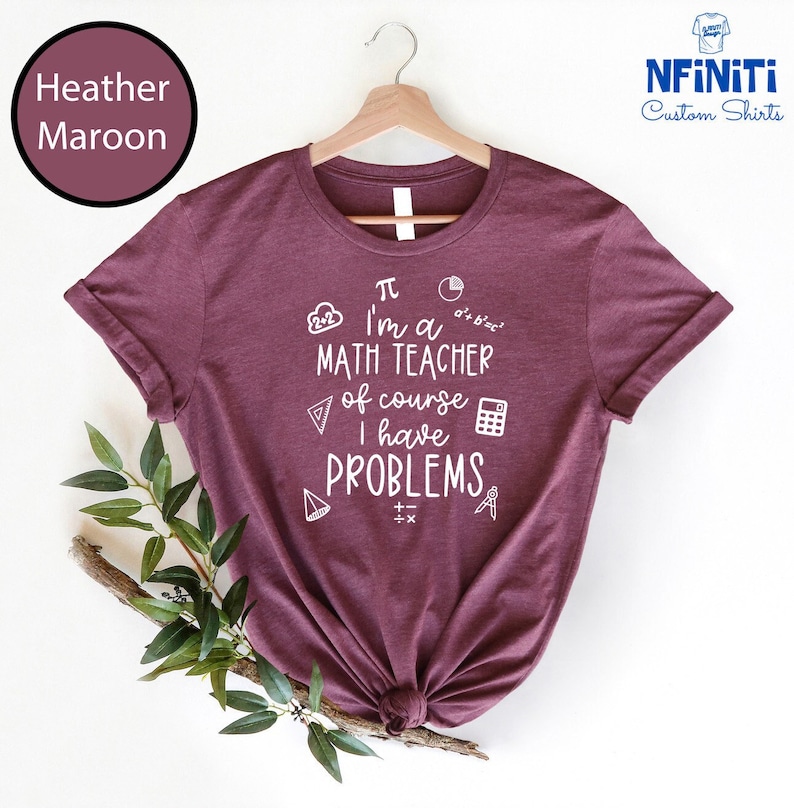 May include: Heather maroon t-shirt with a white graphic that says "I'm a math teacher of course I have problems" with math symbols surrounding the text.