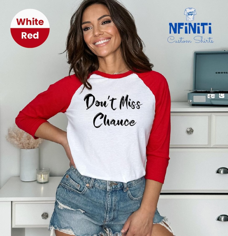 May include: A white and red baseball tee shirt with the text "Don't Miss Chance" printed in black on the front.