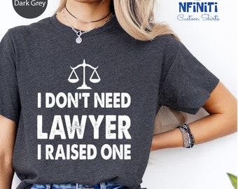 May include: Heather dark grey t-shirt with a white graphic of a scale and the text "I don't need lawyer I raised one".