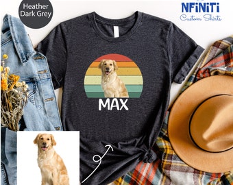 May include: Heather dark grey t-shirt featuring a golden retriever illustration within a retro sunset design. The dog's name, "MAX", is printed in white below the image. The shirt is part of the "NFINITI Custom Shirts" collection.