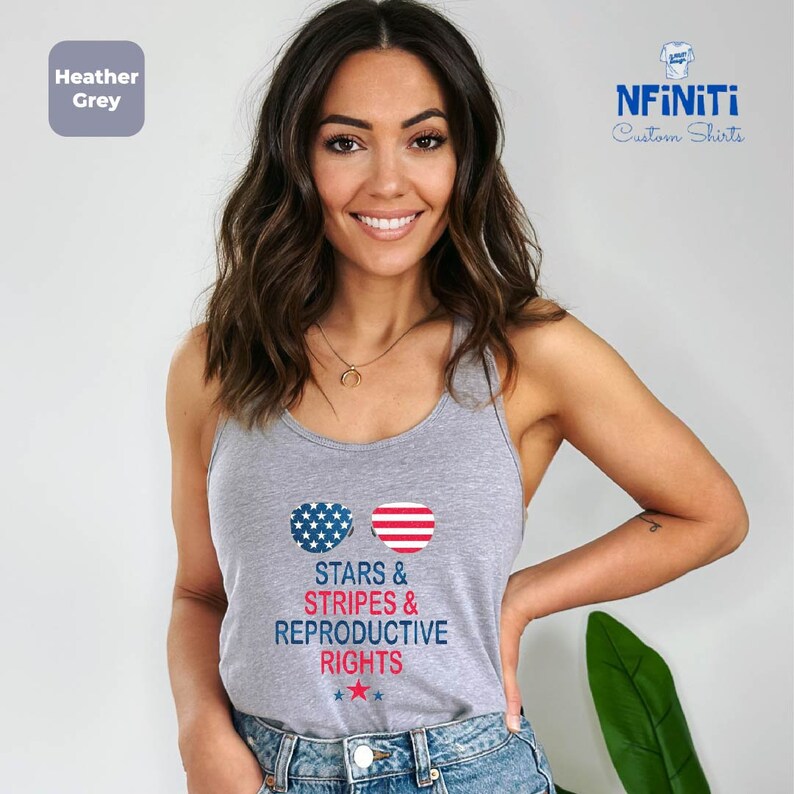 a woman wearing a tank top that says stars and stripes and reproductive