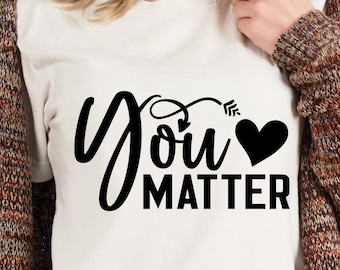 May include: White t-shirt with black text that reads "You Matter" with a heart and arrow graphic.