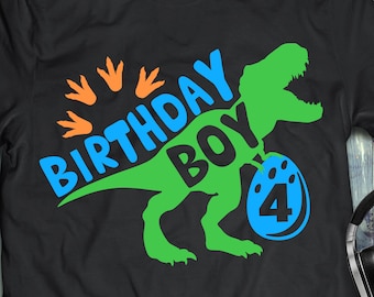 May include: A black t-shirt with a green dinosaur holding a blue egg with the number 4 on it. The text "Birthday Boy" is written in blue and orange on the shirt.