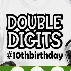 May include: White t-shirt with black text that reads "DOUBLE DIGITS #10thbirthday". The text is in a bold, cartoon-like font. The shirt is a mockup on a white background.