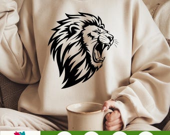 May include: A black and white illustration of a roaring lion's head. The lion has a thick mane and is looking to the right. The image is on a beige sweatshirt.